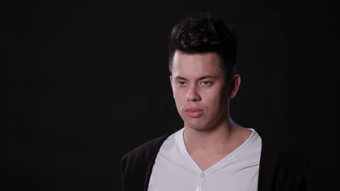 A Man Mimicing Against a Black Background Stock Footage 87316641