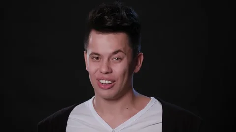 A Man Mimicing Against a Black Background Stock Footage 87322838