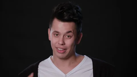 A Man Mimicing Against a Black Background Stock Footage 87323769