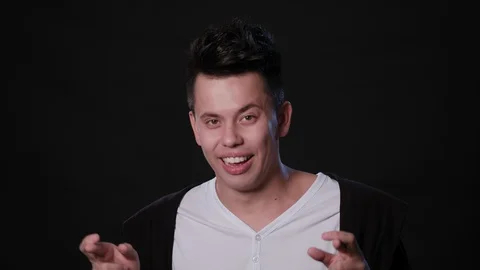 A Man Mimicing Against a Black Background Stock Footage 87324211