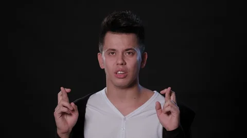 A Man Mimicing Against a Black Background Stock Footage 87327894