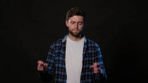 A Man Mimicing Against a Black Background Stock Footage 88415771