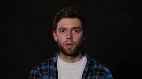 A Man Mimicing Against a Black Background Stock Footage 88443127