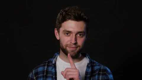 A Man Mimicing Against a Black Background Stock Footage 88443517