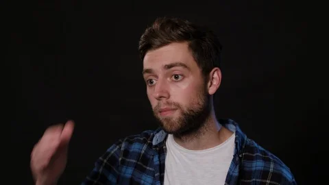 A Man Mimicing Against a Black Background Stock Footage 88463275