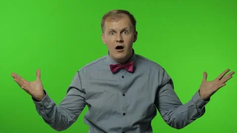 Man is mind blowing by your statement on chroma key background. Showing Stock Photos