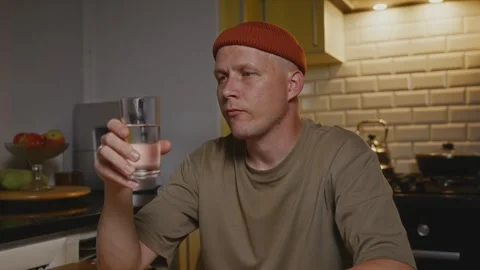 Man mindfully drinking water indoors as part of calm routine Stock Footage 317554231