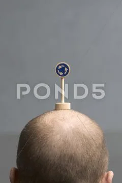 A man with a miniature roundabout road sign on his head Stock Photos