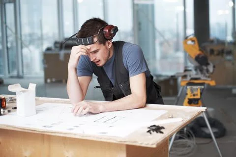 Man, mistake or architect with floor plan, stress or engineering issue for Stock Photos