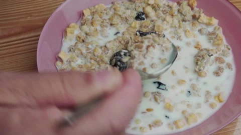 Man mix muesli with a spoon Stock Footage 243584192
