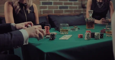 Man mixes and distributes a deck of cards. Company plays poker. Gaming chips Video stock 105883766