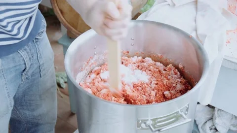 Man mixes the mashed pepper with salt in a stainless steel saucepan Stock Footage 151201859