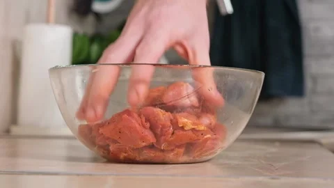 Man mixes sliced pork, beef, chicken, turkey with spices, salt, pepper, herbs Stock Footage 224516136
