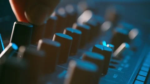 Man mixes tracks on audio console at stroboscope light Stock Footage 296748395
