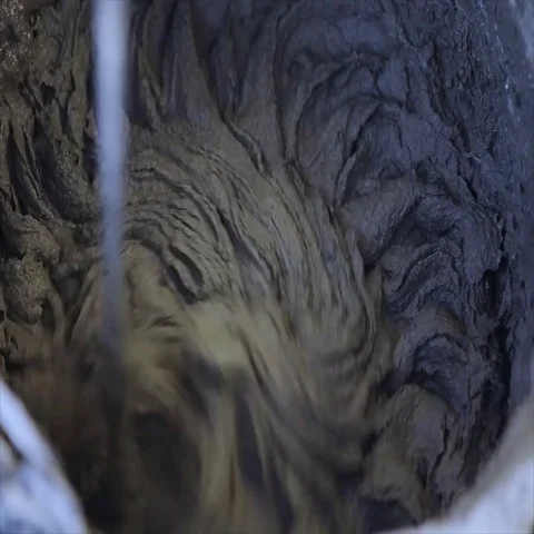 Man mixing concrete solution with hand drill, close-up Stock Footage 69460090