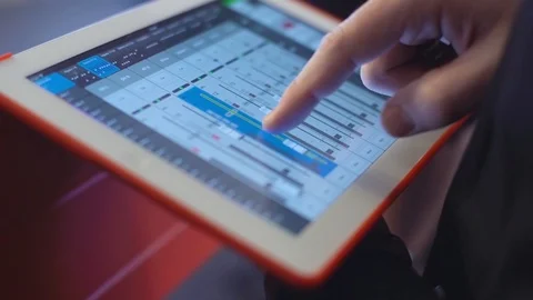 Man with mixing console on tablet check sound on event, music, technology Видео 86015627