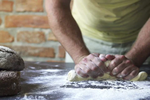 Man mixing flour with dough on the table, slow motion at 240 fps Stock Footage 31701794