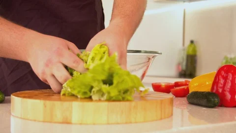 Man mixing fresh vegetable salad Stock Footage 130057073