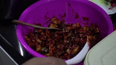 Man mixing Fruits and peanut sauce, for making rojak, a spicy fruit salad. Stock Footage