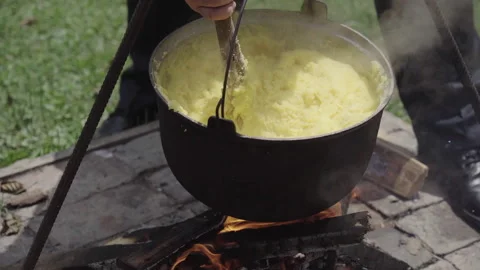 Man Mixing Polenta in Cauldron Stock Footage 247638579
