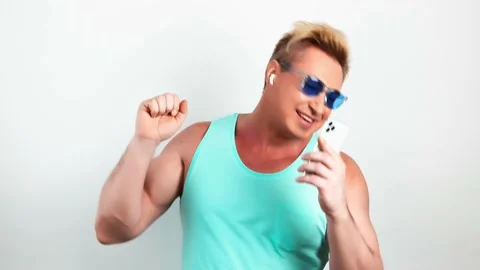 Man, mobile cell phone, dance in headphones Video stock 239455518