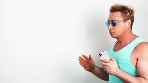 Man, mobile cell phone, dance in headphones for entertainment, streaming service 動画素材 245571321