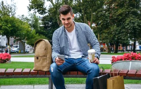 Man with mobile looking camera Stock Photos