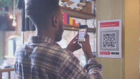 Man With Mobile Phone Checking Into Venue Scanning QR Code During Health Video stock 147672298