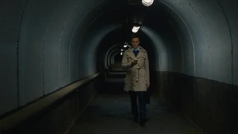 Man with mobile phone going through the tunnel Видео 112039147