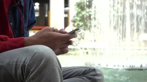 Man with Mobile Phone in Hands sitting chating in the Mall close-up Stock Footage