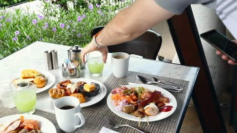 Man with Mobile Phone in Hands Take Pictures and Make Video Breakfast at Hotel Stock Footage 133717465