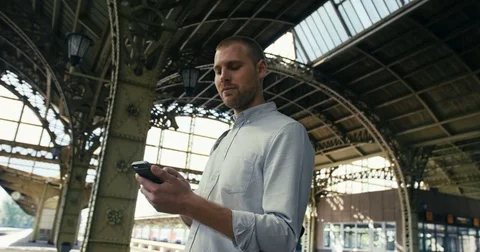 Man With Mobile Phone At Train Platform Stock Footage 78772372