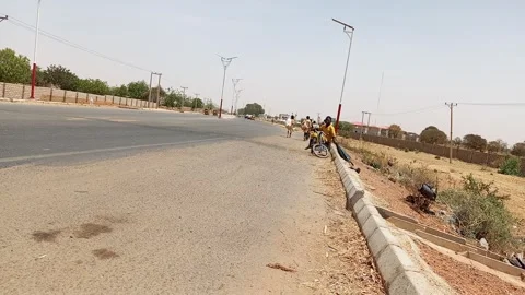 Man With Mobility Impairment In Three Wheeler On Roadside Kano Nigeria Vídeo Stock 331315739