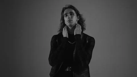 Man Model In Black On Black Background Touches His Neck. Stock Footage 277541400