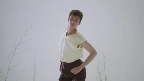 Man model performs expressive dance in studio setting for artistic shoot Stock Footage 319925045