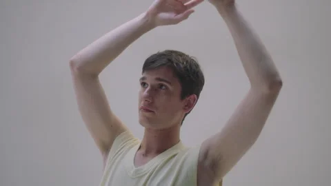 Man model showcasing expressive dance poses in an artistic studio setting Stock Footage 319925376