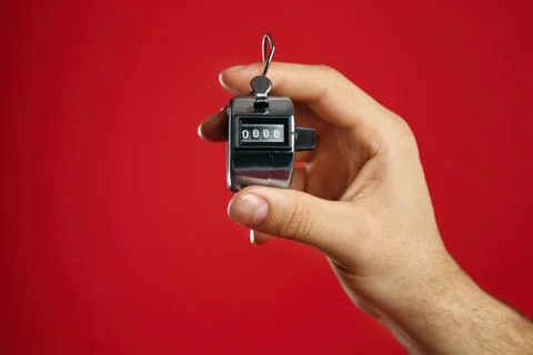 Man modern digital timer on red background, closeup Stock Photos