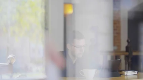 Man with modern laptop drinking tea in cafe. Young man with modern laptop in Stock Footage 89831969