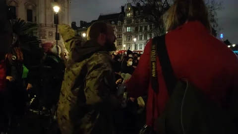 A MAN WITH MOHAWK TELLS CROWD TO 'STORM SCOTLAND YARD' AT SARAH EVERARD PROTEST Stock Footage 150399284