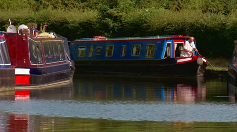 Man Moored Narrowboat on Riverside Stock Footage 56146980