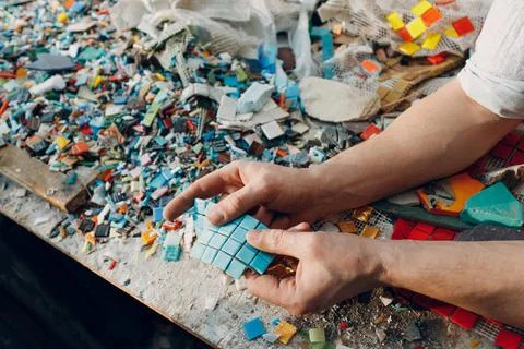Man mosaics master chooses select smalt glass pieces for mosaic panel. Mal... Stock Photos