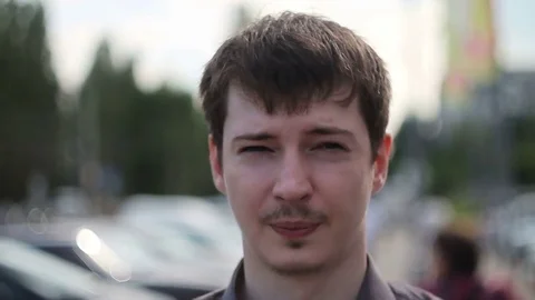 The Man motionlessly is on the street, on a back background people move. Time Video stock 77155906