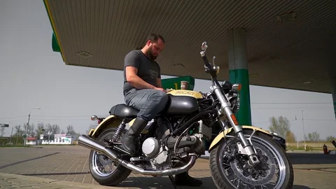 A man on a motorcycle counts money Video stock 88548954