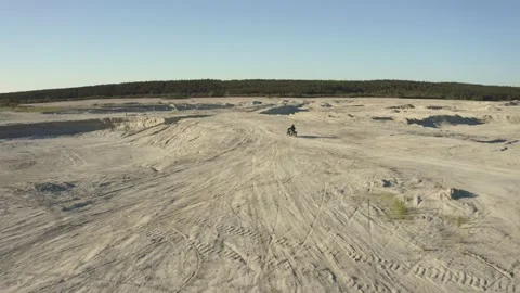A man on a motorcycle drives through the desert Stock-Footage 157101702