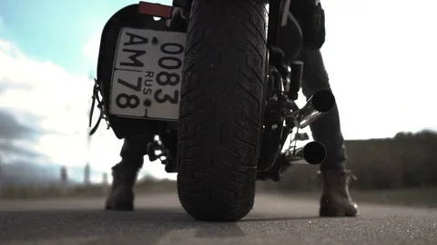 A man on a motorcycle is leaving behind Stock Footage 107723758