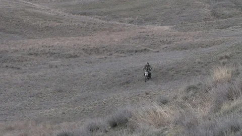 A man on a motorcycle rides on the steppe Stock Footage 119564152