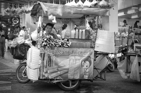 A man on a motorcycle sidecar to sell squeezed sugarcane juice Stock Illustration