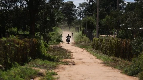 Man on motorcyle passes camera Stock Footage 95496595