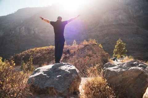 Man in the mountain down the sunlight Stock Photos