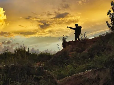 A man on the mountain at dusk Фото